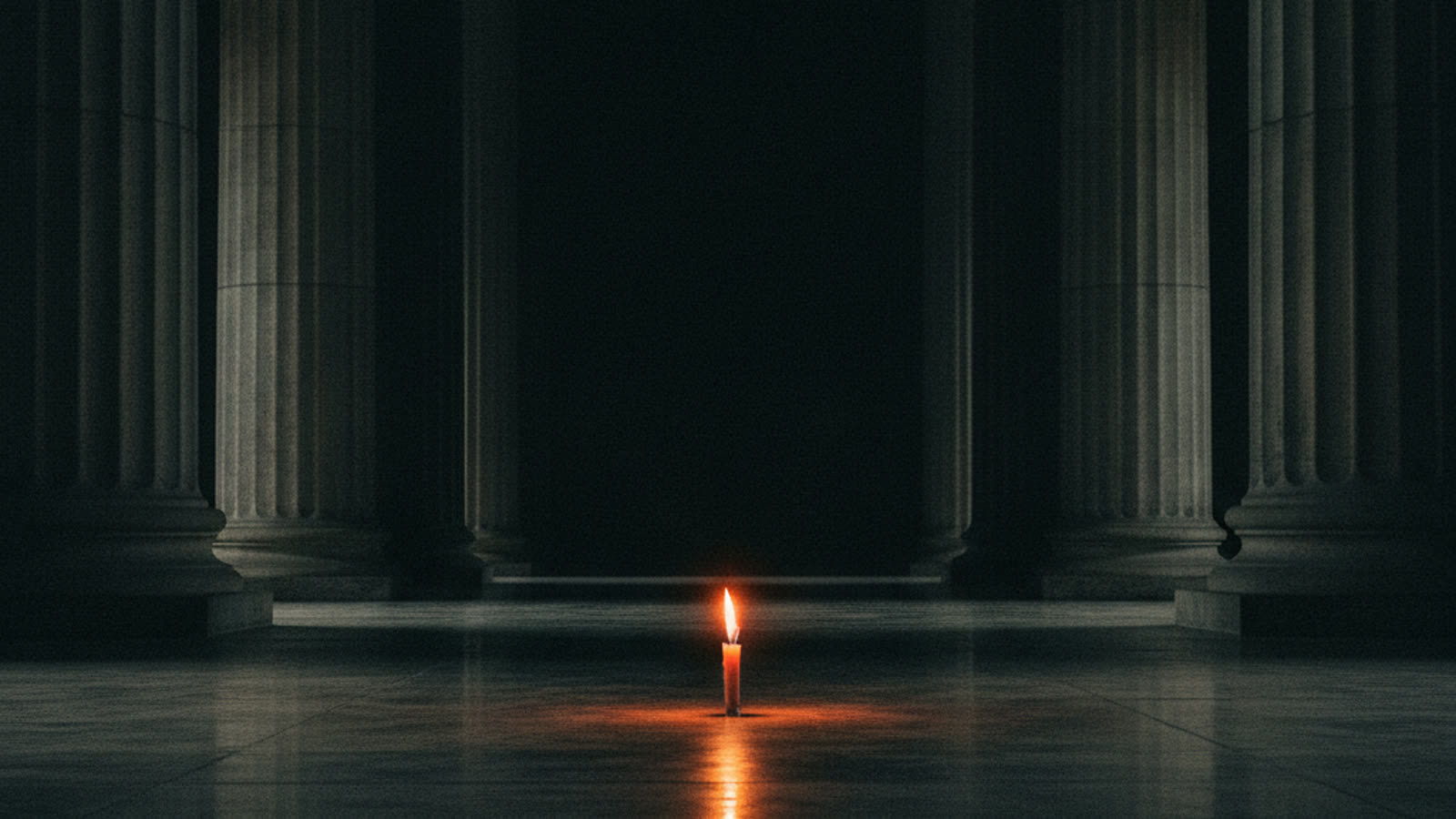 A single small candle burning on a polished floor in a vast dark hall of stone columns.